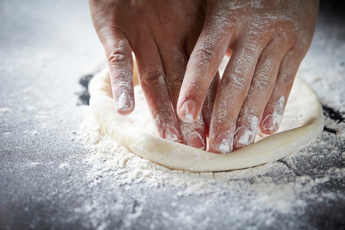 Kneading pizza dough